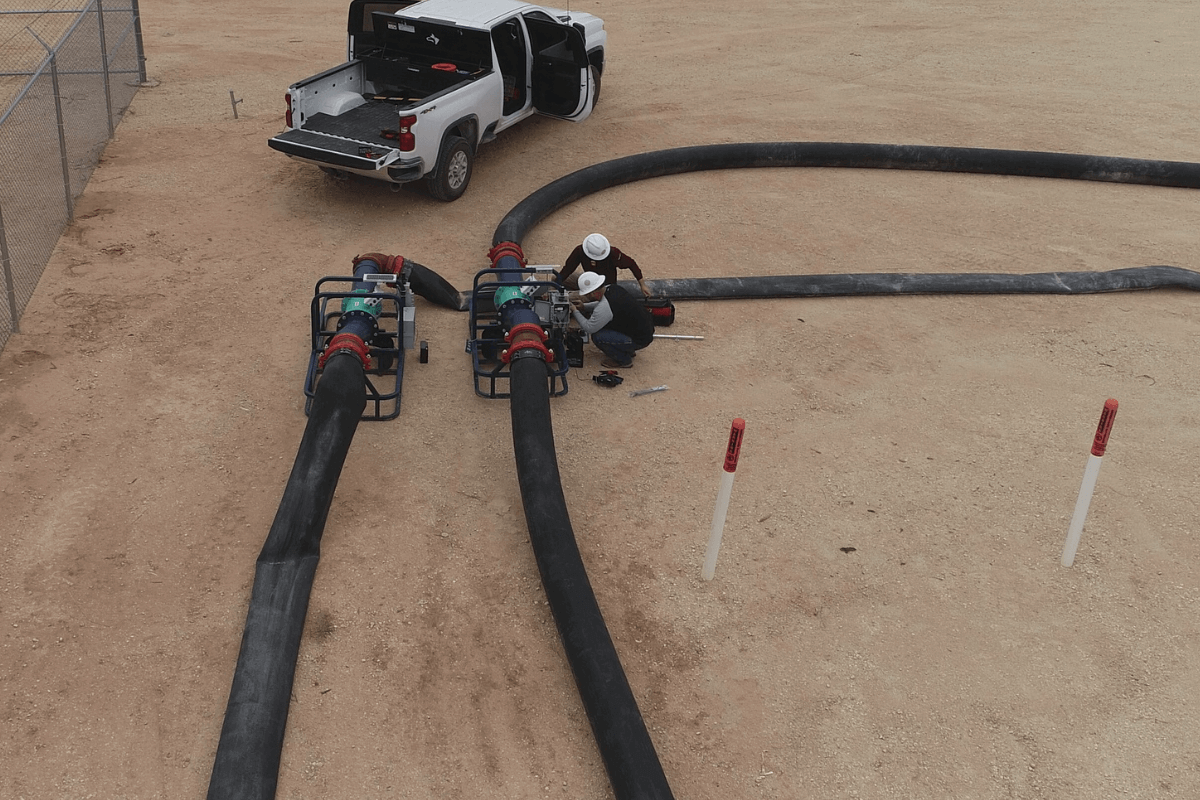 An overhead photo of piping and technicians.