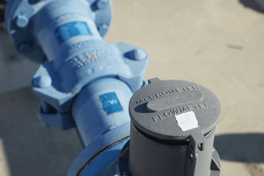 Closeup of a meter and blue pipe.